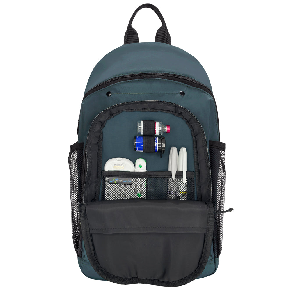 A dark teal backpack shown from the front with its main compartment open, revealing mesh pockets and compartments holding diabetes supplies. The backpack has black zippers, black mesh side pockets, and black top handles, photographed on a plain white background.