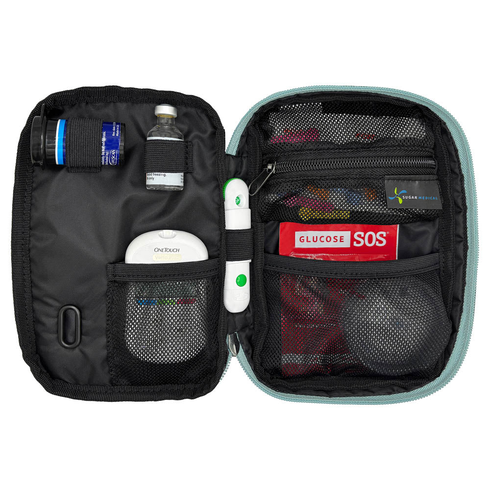 Seafoam tandem diabetes supply case with glucose testing supplies on a white background