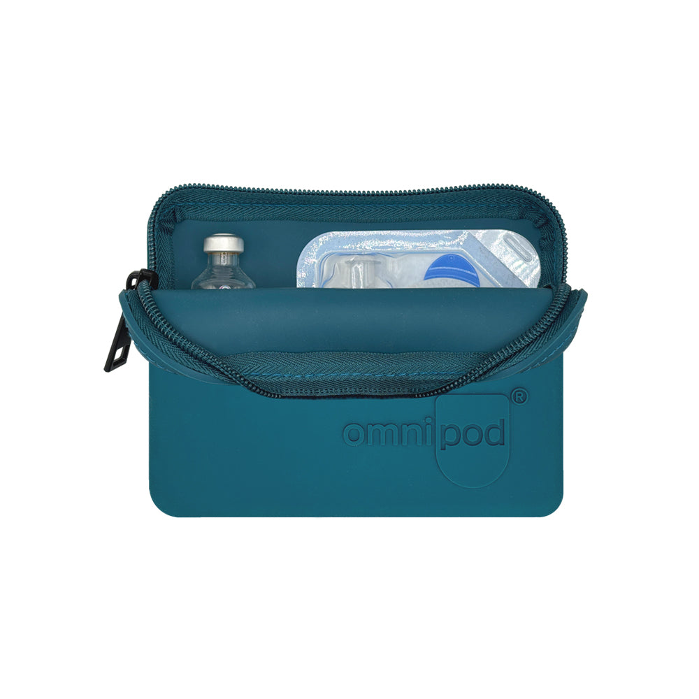 Set up with Omnipod® pod and insulin: The steel blue Omnipod® protective travel case opened to reveal an Omnipod® insulin pod and an insulin vial placed inside, demonstrating the case's organized storage capabilities.