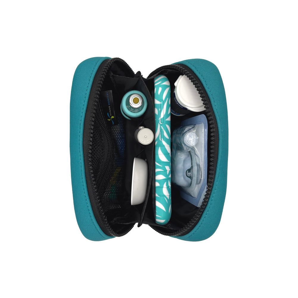 Vertical view of the Omnipod® Metro Supply Case in teal, displaying neatly organized Omnipod® PDM, pod, and other diabetes supplies inside the case.