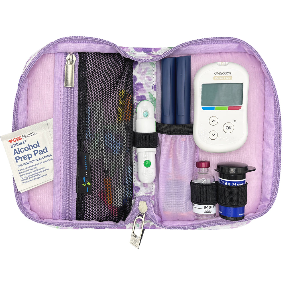 Purple diabetes management kit with glucose meter, lancet device, and other diabetic supplies on a white background