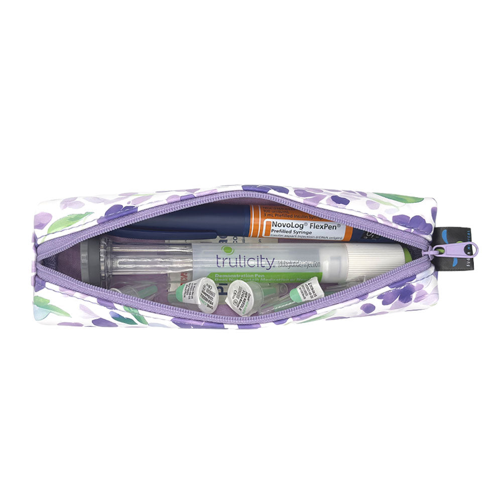 Floral-patterned slim case open with an insulin pen and GPL-1 pen and pen tips in it. 