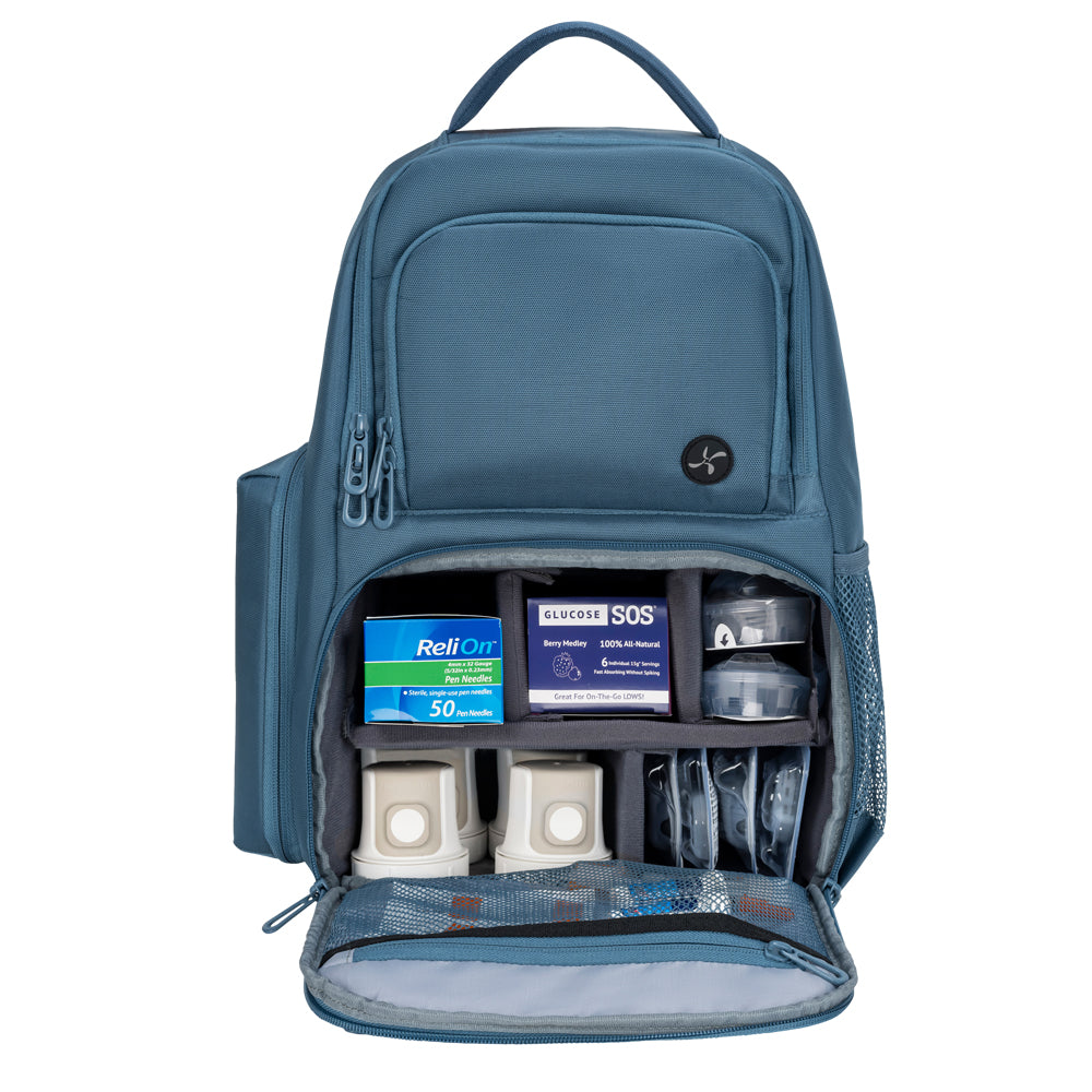 Steel Blue Travel Backpack main pocket open filled with diabetic supplies.