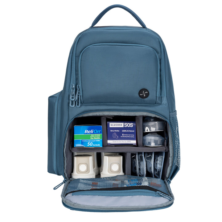Steel Blue Travel Backpack main pocket open filled with diabetic supplies.