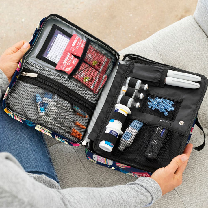 Diabetes Insulated Travel Bag in Vaca all day front compartment for a insulin pen, insulin vial, and more diabetes supplied organized in women's lap. 