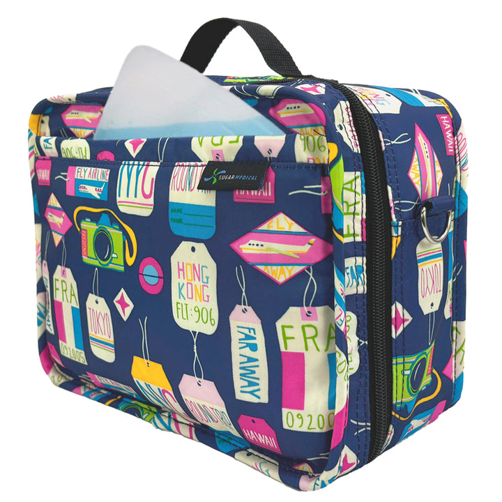 Side of the navy Sugar Medical Insulated Diabetes Supply Travel Bag with colorful travel tags on it with a ice pack in the front pocket. 