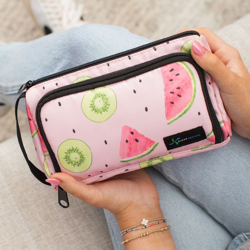 A women sitting with the pink watermelon pattern Insulated Diabetes Insulin Supply Case on her lap. 