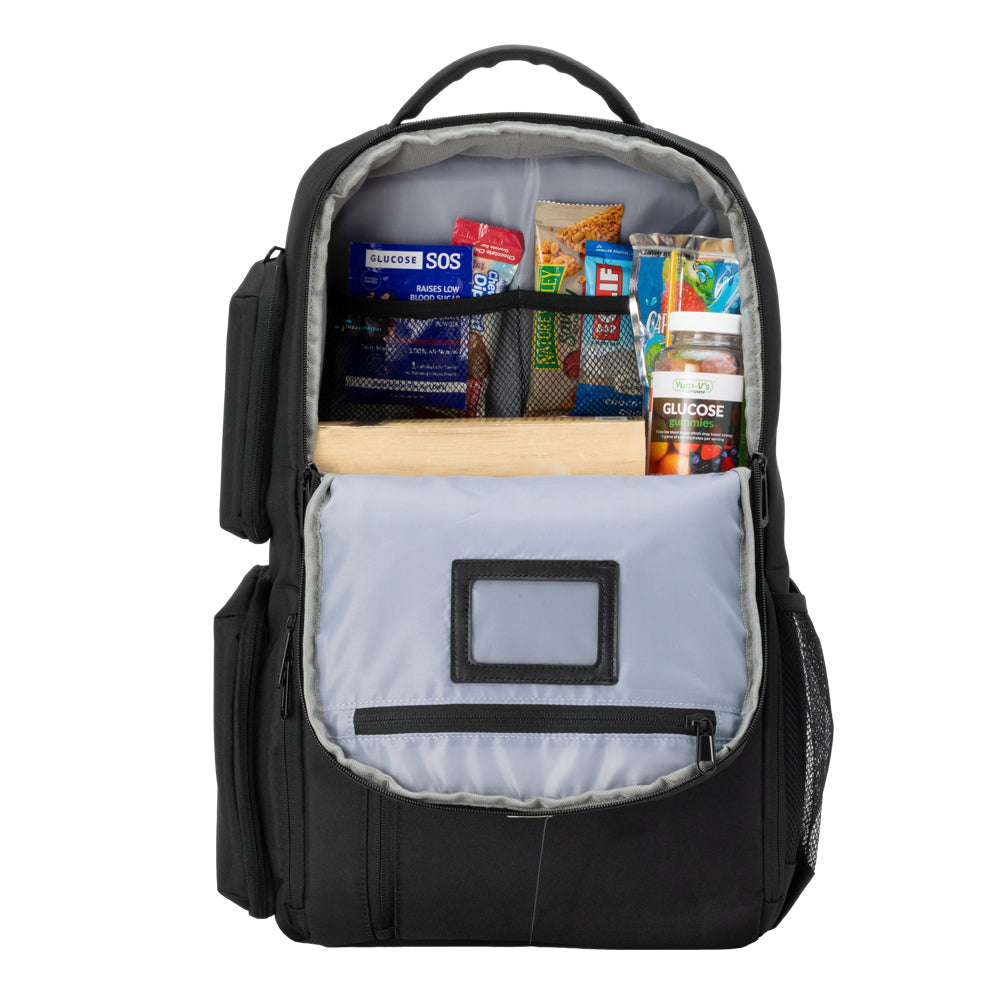 Charcoal grey XL Travel Backpack top pocket open with book, diabetic supply bag, clothes and mesh pocket with chargers. 