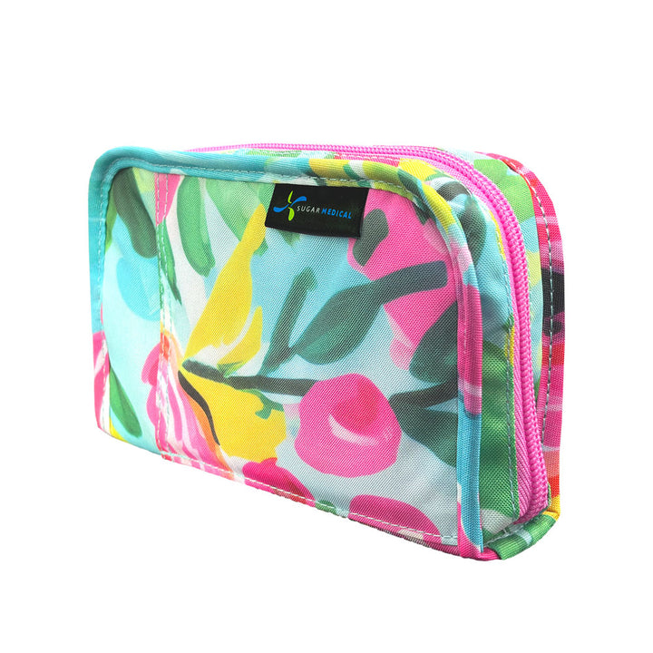 Colorful floral-patterned diabetes supply case with a visible Sugar Medical label and pink zipper on a white background