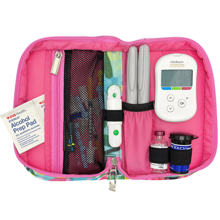 Pink diabetes management kit with insulin pump, needles, and other supplies on a white background