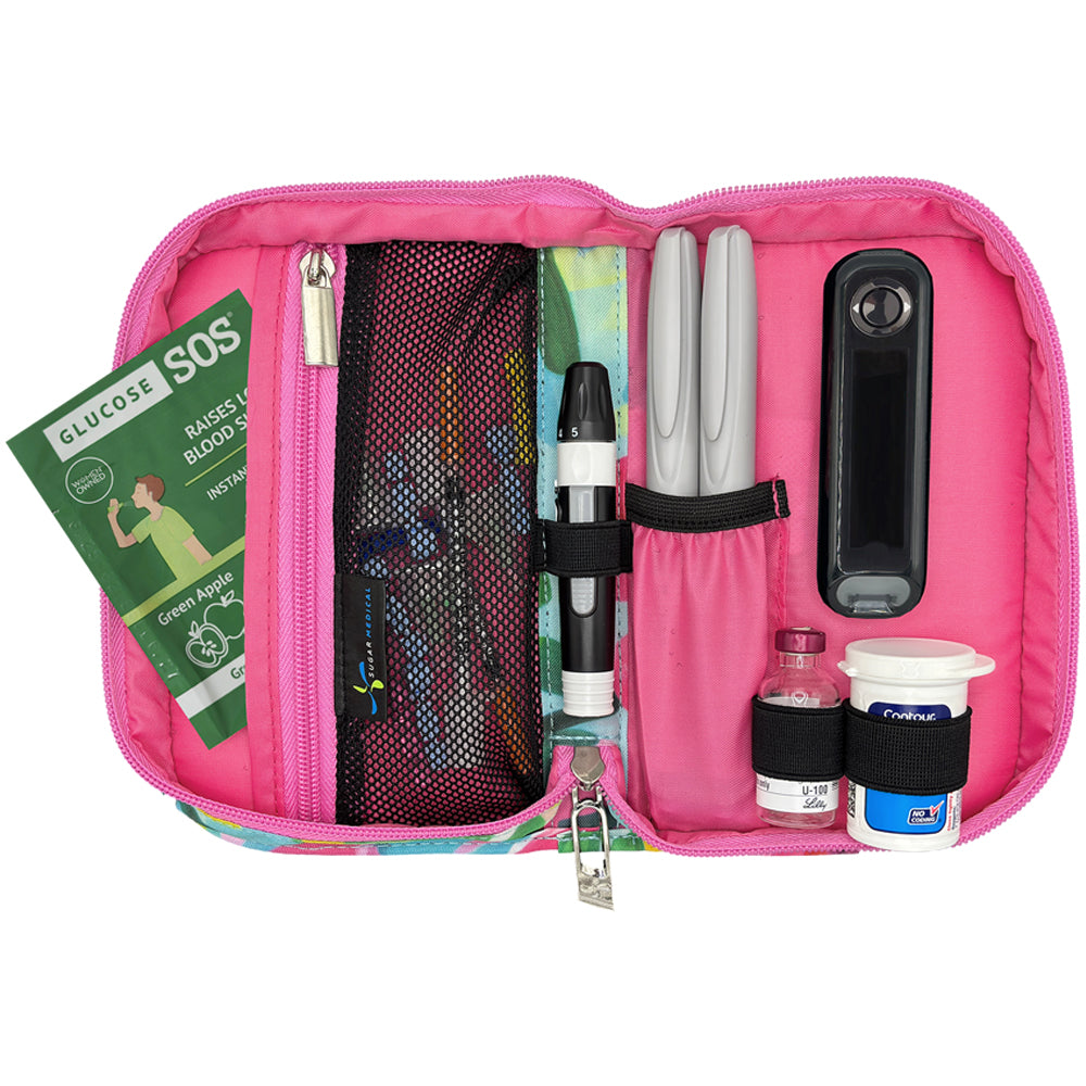 Pink diabetes management kit with various supplies on a white background