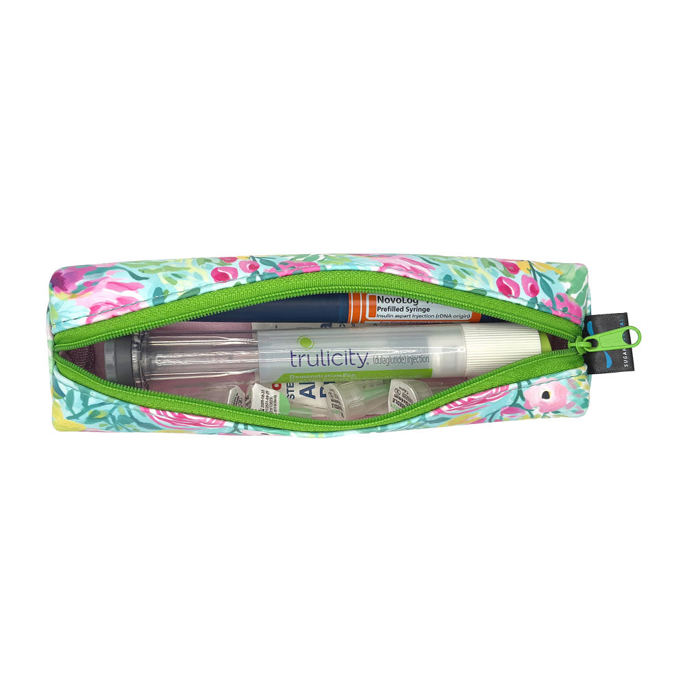 Floral-patterned slim case open with an insulin pen and GPL-1 pen and pen tips in it. 