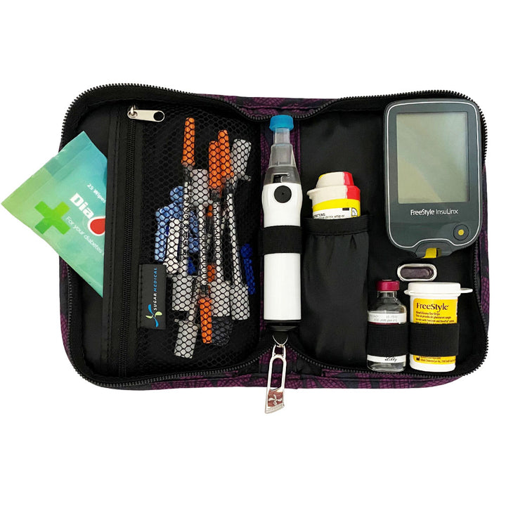 Sugar Medical Diabetes Deluxe Supply Case in black with purple flowers inside set up with glucose meter, test strips, lancet, genteel and glucagon.