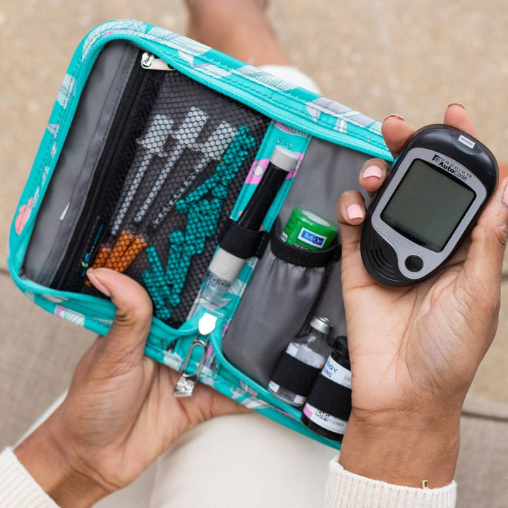 Sugar Medical Diabetes Deluxe Supply Case opened on women's lap with diabetic supplies in it.