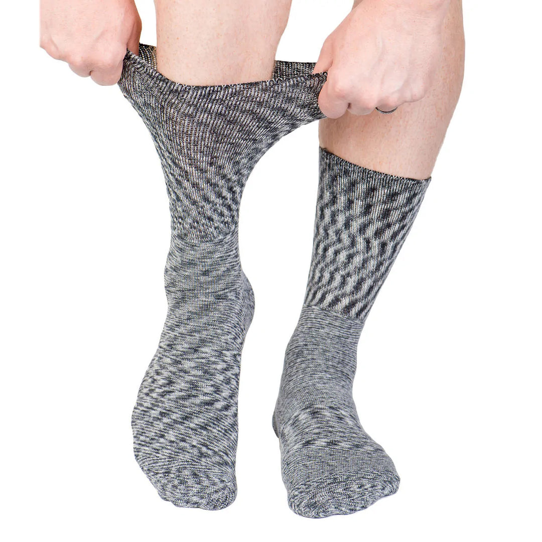 Man wearing the diabetes socks and stretching them at the calf to show that they are non-binding and easily stretch.