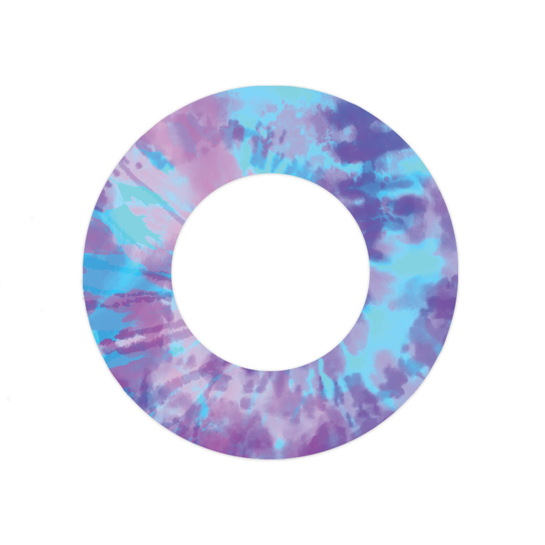 A pastel purple, blue, and pink adhesive tape in a tie-dye pattern designed to fit around the Libre Freestyle sensor.