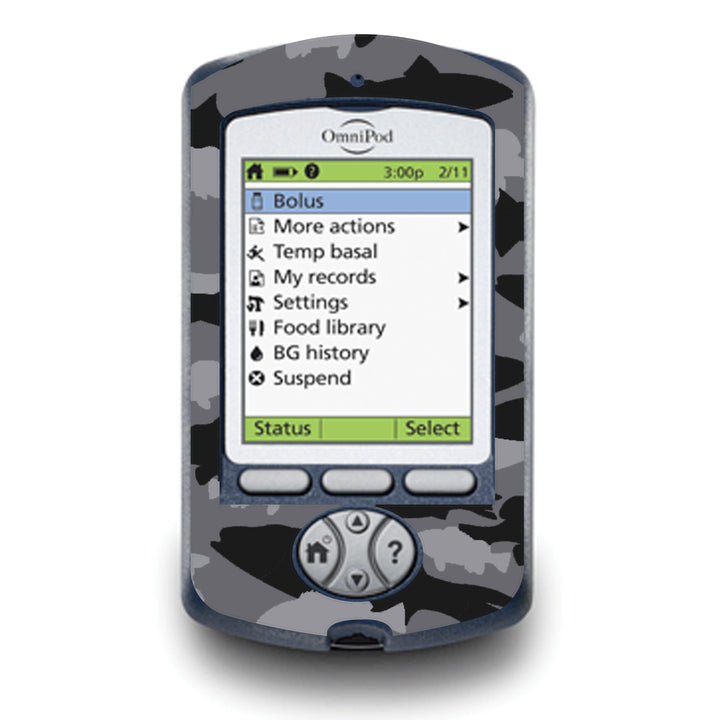 A fun sticker that has black and grey fish in a camouflage pattern on the Omnipod PDM device and does not obstruct buttons or sensors.